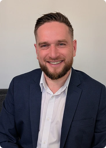 Benjamin Hyneck smiling in a navy blazer